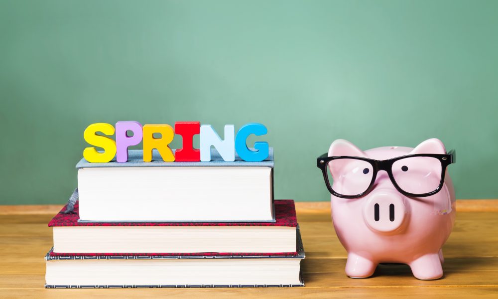 Spring Semester theme with textbooks and piggy bank and green chalkboard