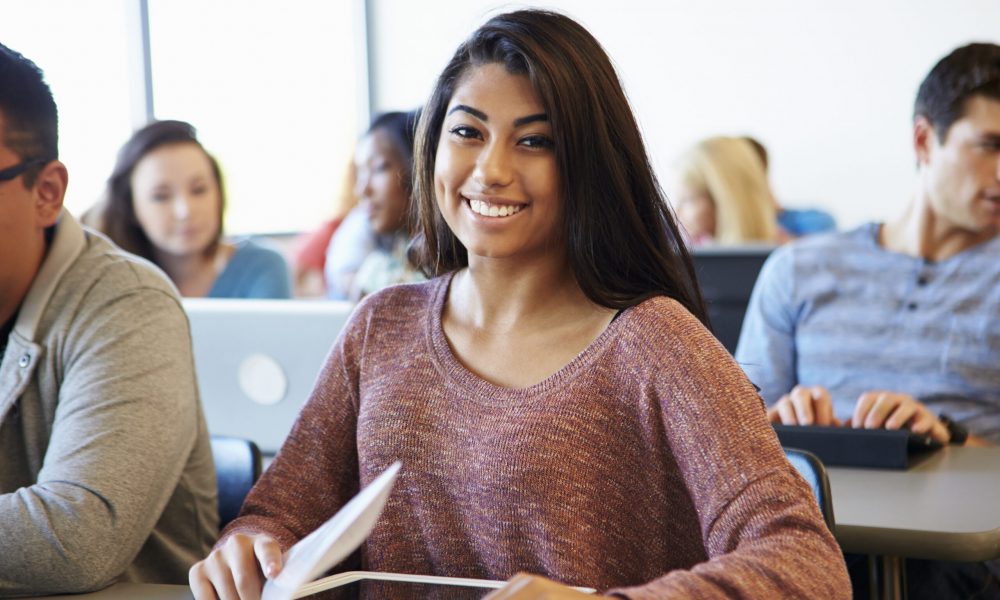 Female University Student Using Digital Tablet In Classroom